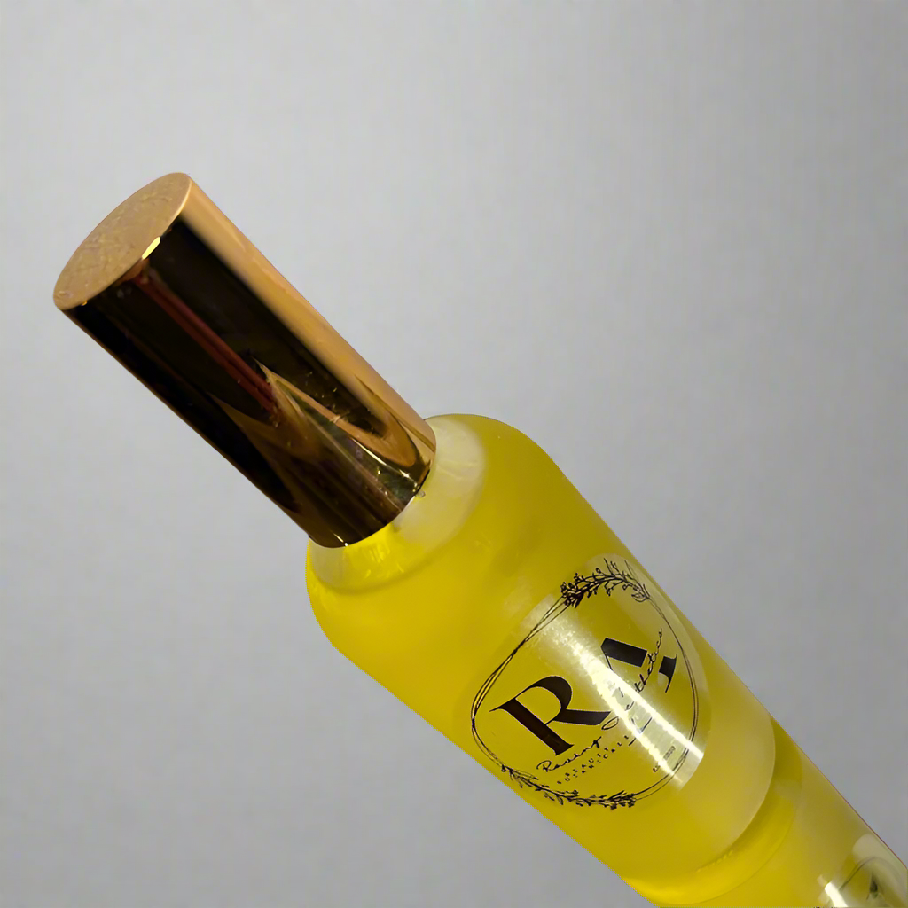 A bottle of light-weight lavender calming facial and body oil with a golden cap on a transparent background.